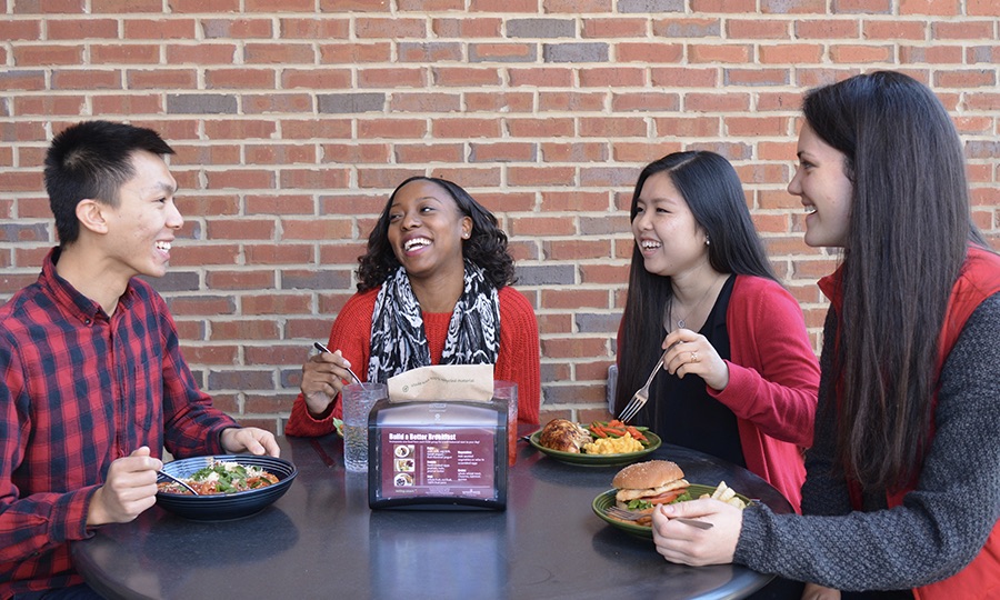 Students eating at a dining hall.