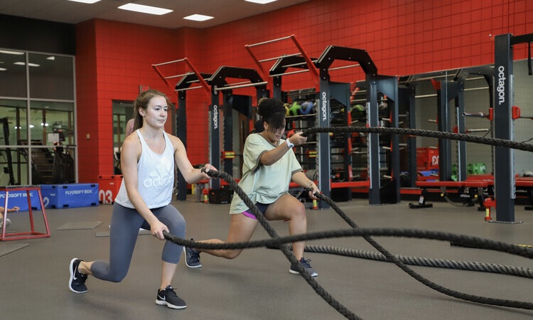 Two students working out with ropes at Ramsey Student Center.